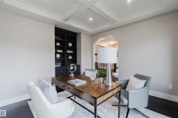 Room featuring dark wood-finish flooring, recessed lighting, and a coffered ceiling - 