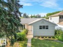 Single-story residence featuring light-colored siding and a dark shingle roof - 14612 93 Ave Nw, Edmonton, AB 