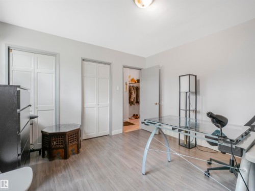Light grey wood-finish flooring complements the neutral wall color - 14612 93 Ave Nw, Edmonton, AB 