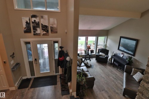 Vaulted ceilings and wood-finish flooring define this expansive living area - 42 Alpaugh Crst, Leduc, AB 