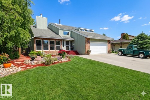 Contemporary exterior with light green siding and brick accents - 42 Alpaugh Crst, Leduc, AB 