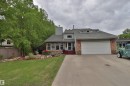 Two-story residence featuring a gray exterior and a brick facade - 42 Alpaugh Crst, Leduc, AB 