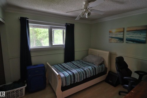 Interior space featuring light-toned walls with wainscoting and crown molding - 42 Alpaugh Crst, Leduc, AB 