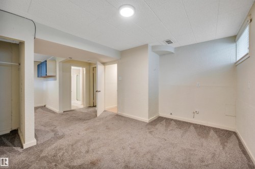 Carpeted room with recessed lighting and a window - 9624 77 Avenue, Edmonton, AB 