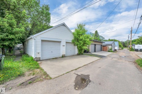 Detached two-car garage with white vinyl siding and a concrete driveway - 9624 77 Avenue, Edmonton, AB 
