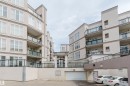 Multi-story residential building featuring textured exterior finishes and multiple private balconies with glass railings - 323 4831 104A Street, Edmonton, AB 