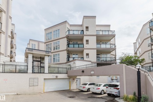 Multi-story building exterior with balconies featuring glass railings - 323 4831 104A Street, Edmonton, AB 