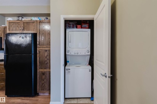 In-unit stackable washer and dryer within a dedicated closet - 323 4831 104A Street, Edmonton, AB 