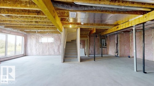 Unfinished basement with concrete flooring and exposed wood ceiling joists - 3918 3A Avenue, Edmonton, AB 