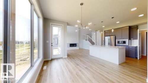 Expansive open-concept living space with wood-finish flooring - 3918 3A Avenue, Edmonton, AB 