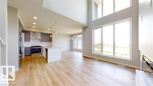 Open-concept living space with wood-finish flooring throughout - 3918 3A Avenue, Edmonton, AB 