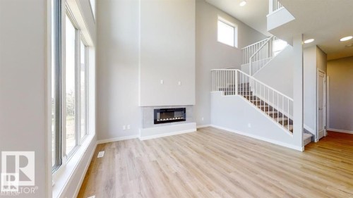 Open-concept living space with high ceilings and wood-finish flooring - 3918 3A Avenue, Edmonton, AB 