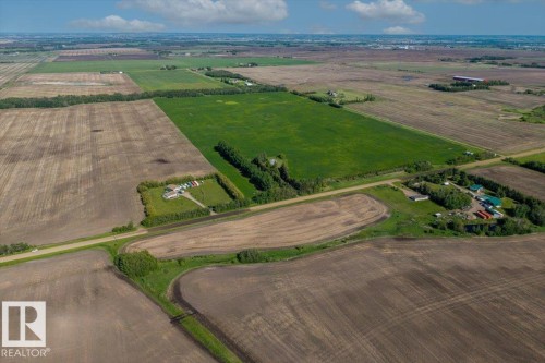 Expansive agricultural property featuring multiple cultivated fields, established tree lines, and direct road frontage - 0 0, Rural Sturgeon County, AB 