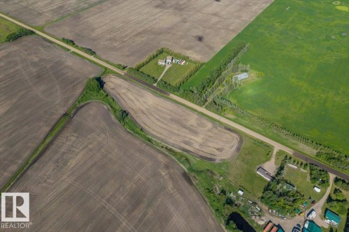 Expansive rural property featuring cultivated fields and green spaces, bordered by a road - 0 0, Rural Sturgeon County, AB 