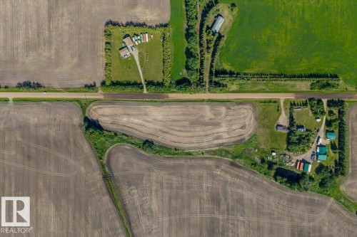 Aerial perspective showcasing agricultural land with cultivated fields and established treelines - 0 0, Rural Sturgeon County, AB 