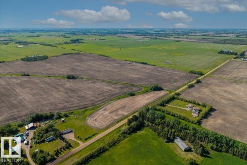 Expansive agricultural land featuring cultivated fields, natural tree lines, and a gravel road network - 0 0, Rural Sturgeon County, AB 