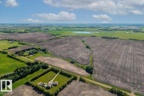 Expansive rural property featuring cultivated land, established tree lines, a private drive, and multiple outbuildings - 0 0, Rural Sturgeon County, AB 
