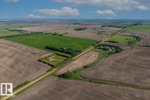 Expansive agricultural landscape featuring large cultivated fields and visible roadways - 0 0, Rural Sturgeon County, AB 