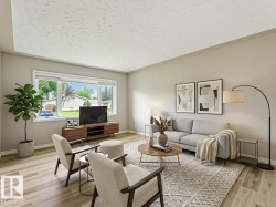 Spacious living area featuring light wood-finish flooring, a large window, neutral wall tones, and a textured ceiling - 