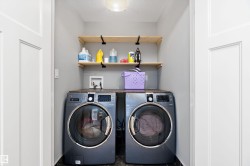 Dedicated laundry area featuring dual front-load machines - 