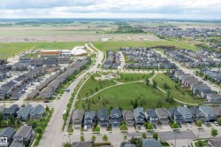 Aerial perspective showcasing a residential development with a central green space - 