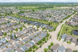 Aerial perspective of a developed residential community featuring individual homes with varied architectural styles - 