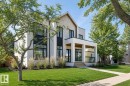 Contemporary residence featuring a prominent gabled roofline and a combination of white stucco and light-toned stone cladding - 10514 134 Street, Edmonton, AB 