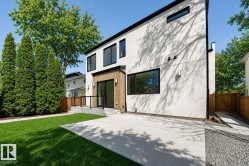 Contemporary white stucco exterior with black trim windows - 