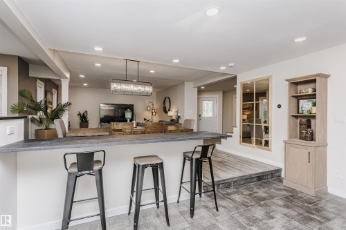 Breakfast bar with stone-finish countertop - 5610 57 Avenue, Beaumont, AB 