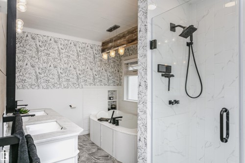 Bathroom featuring a walk-in shower with large format tile and matte black fixtures - 5610 57 Avenue, Beaumont, AB 