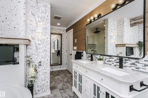 Dual vanity with white cabinetry, integrated sinks, and stone countertops - 5610 57 Avenue, Beaumont, AB 