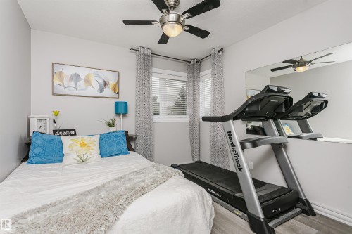 Bedroom featuring light gray walls and wood-finish flooring - 5610 57 Avenue, Beaumont, AB 