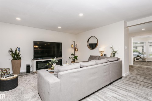 Living area featuring light wood-finish flooring, recessed lighting, and white wall finishes - 5610 57 Avenue, Beaumont, AB 