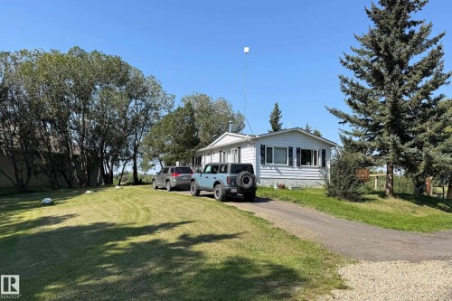 White siding residence with dark shutters and a light-colored roof - 3054 28 Avenue, Edmonton, AB 