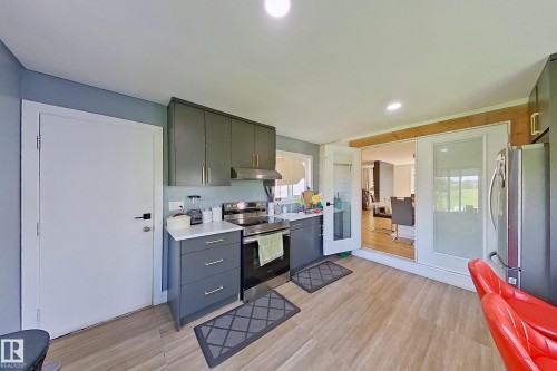 Kitchen featuring shaker-style cabinetry, stainless steel appliances, and a light-toned countertop - 3054 28 Avenue, Edmonton, AB 