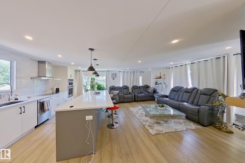 Open-concept living space with wood-finish flooring throughout - 3054 28 Avenue, Edmonton, AB 