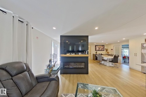 Spacious interior featuring wood-finish flooring and recessed lighting - 3054 28 Avenue, Edmonton, AB 