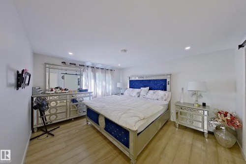 Light wood-finish flooring complements the neutral wall color - 3054 28 Avenue, Edmonton, AB 
