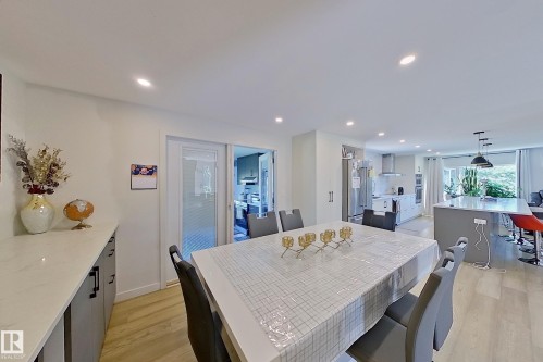 Open-concept dining area featuring recessed lighting and wood-finish flooring - 3054 28 Avenue, Edmonton, AB 