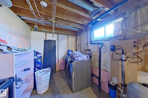 Unfinished basement area featuring a utility window, exposed ceiling joists, and concrete flooring - 3054 28 Avenue, Edmonton, AB 