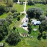 Expansive property featuring a gravel driveway, detached garage, and a single-story residence - 3054 28 Avenue, Edmonton, AB 