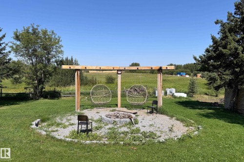Outdoor gathering area featuring a gravel base and a built-in fire pit - 3054 28 Avenue, Edmonton, AB 