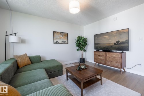 Living area featuring all-new light wood-finish flooring - 807 10011 116 Street, Edmonton, AB 