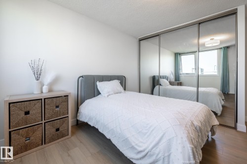Mirrored closet doors add extra light in this bedroom - 807 10011 116 Street, Edmonton, AB 