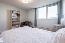 Spacious room featuring large windows, and light-colored walls - 