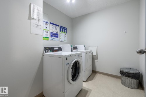 Dedicated laundry area featuring a front-load washing machine and a top-load dryer - 807 10011 116 Street, Edmonton, AB 