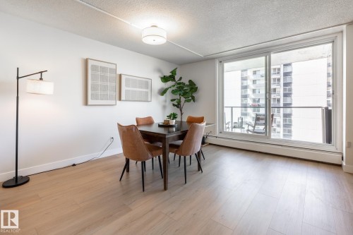 Bright dining area featuring new wood-finish flooring and a white wall finish - 807 10011 116 Street, Edmonton, AB 