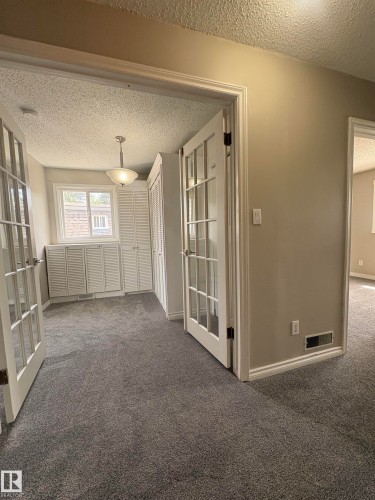 Interior room featuring gray carpet flooring and neutral wall tones - 11 Greenfield Estates, St. Albert, AB 