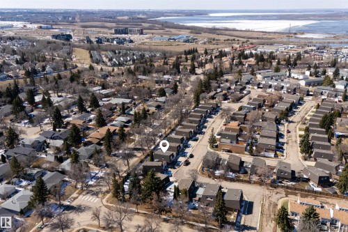 Aerial perspective showcasing a residential neighborhood with a mix of detached homes and townhouses - 11 Greenfield Estates, St. Albert, AB 