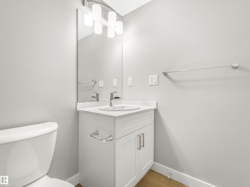 Bathroom vanity with a white rectangular sink, chrome faucet, and white countertop - 318 1506 Tamarack Boulevard, Edmonton, AB 